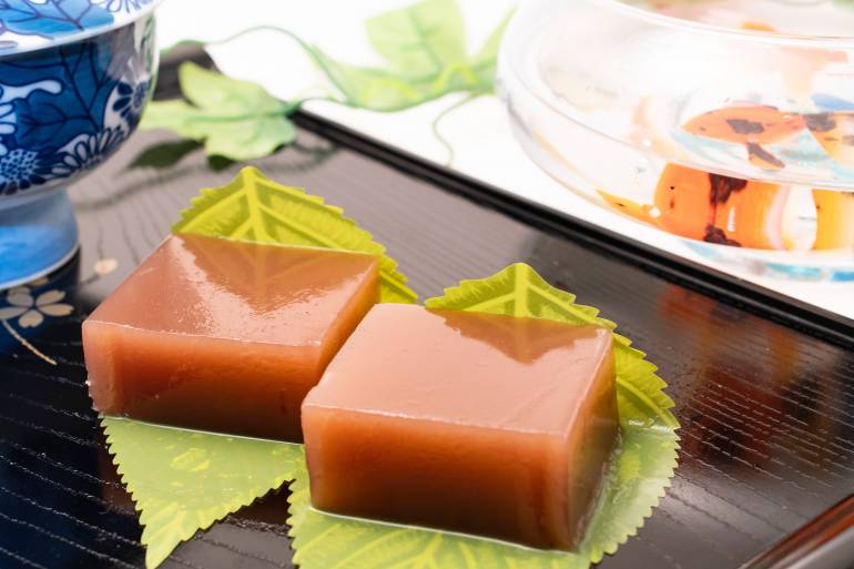 two square adzuki colored desserts on a plate